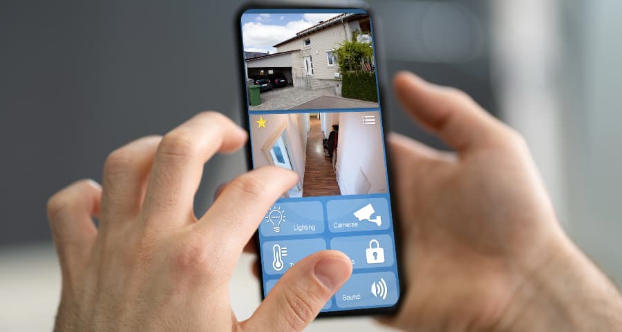Homeowner looking at video camera streams on a mobile device